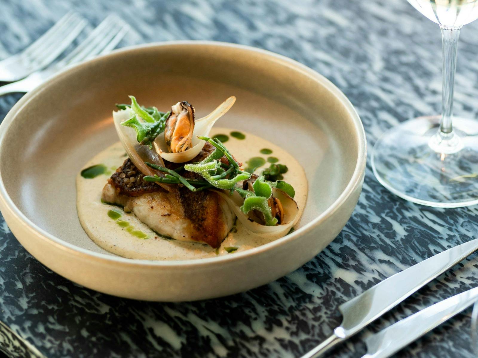 Gold band snapper, pearl onions, smoked mussel butter and coastal greens