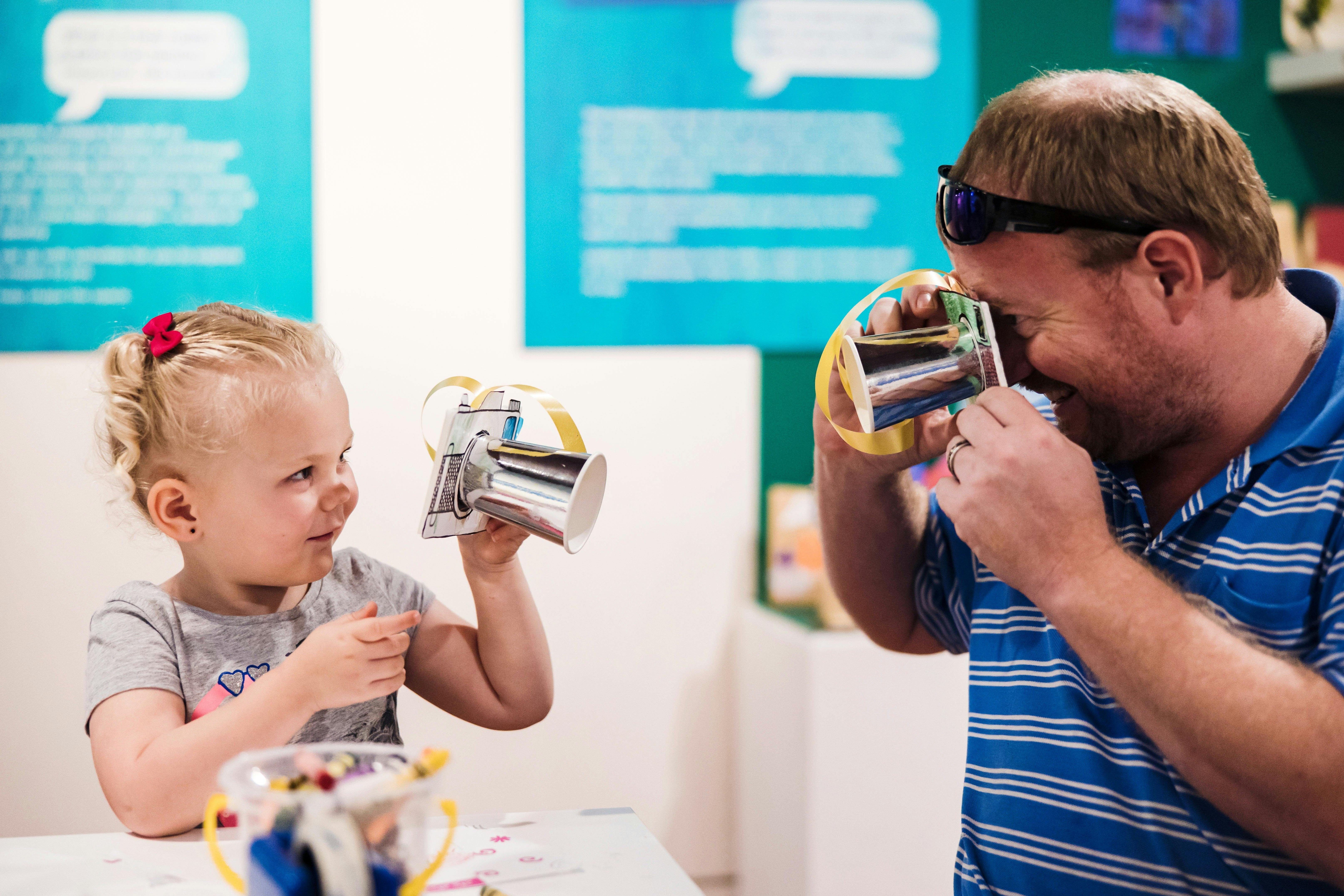 Young girl and man interact with craft items as per of the Term Time Tots program