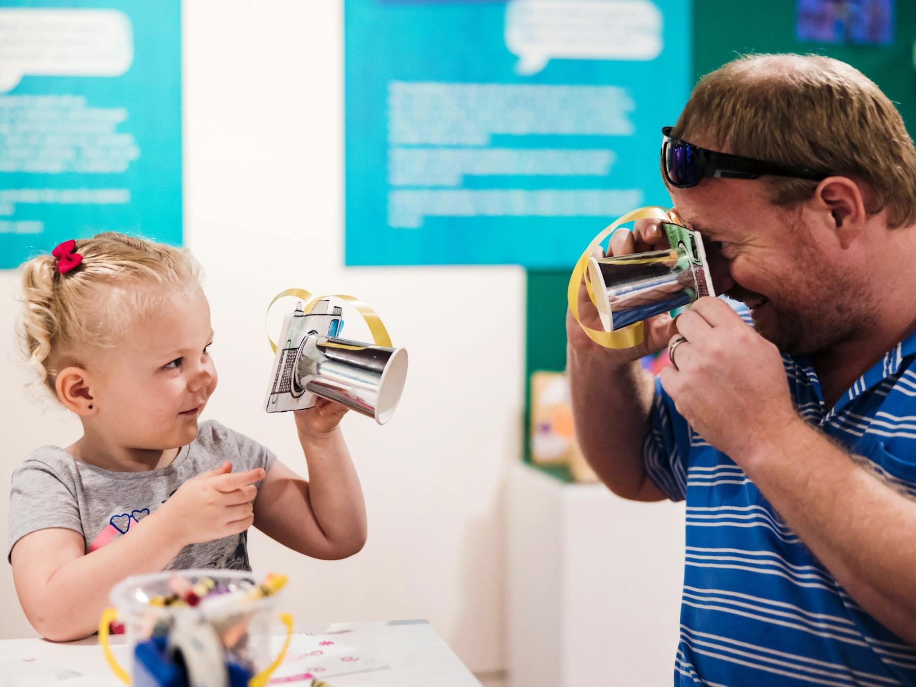 Young girl and man interact with craft items as per of the Term Time Tots program