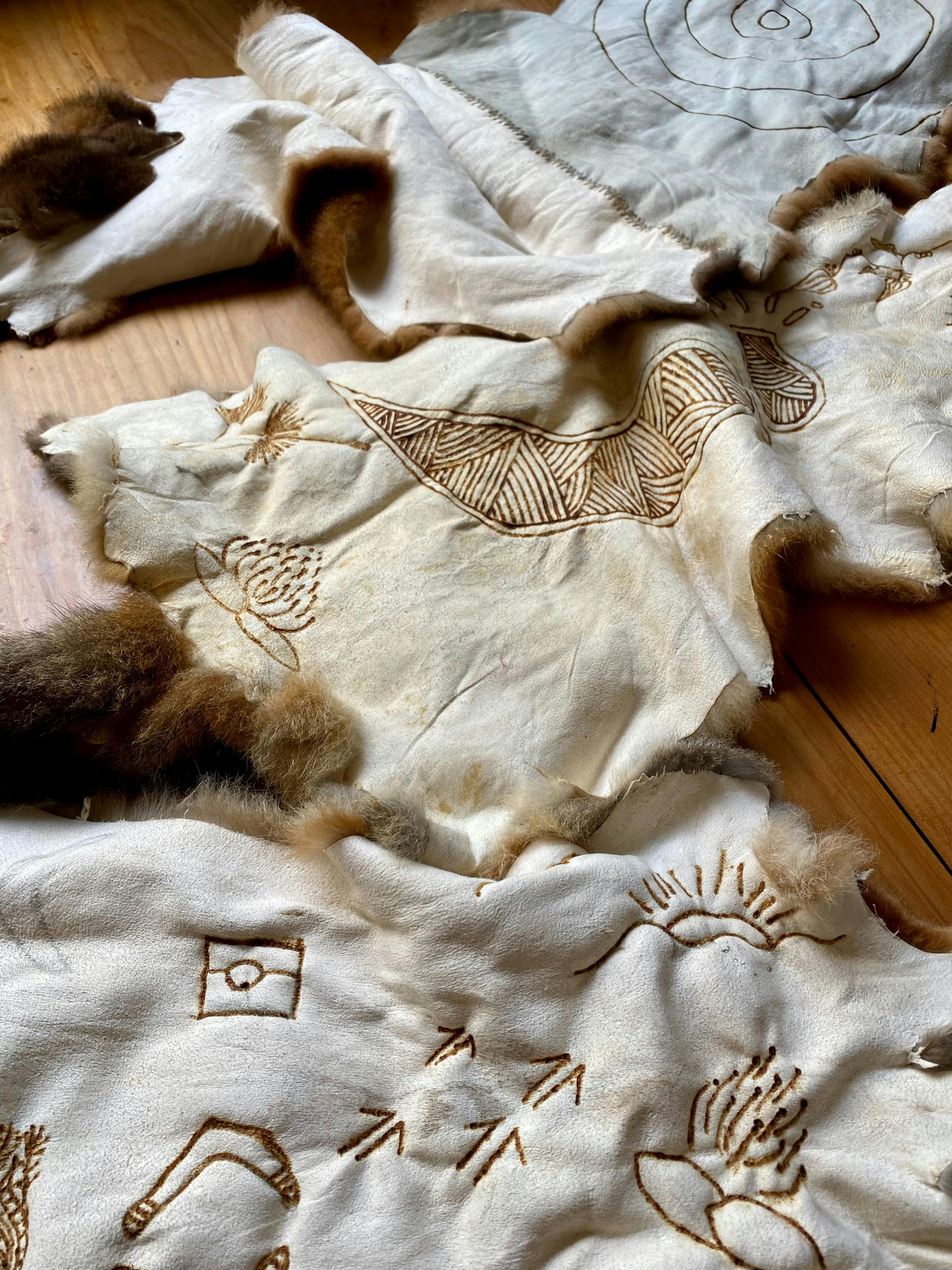 Possum skin with art work burnt onto the skin.