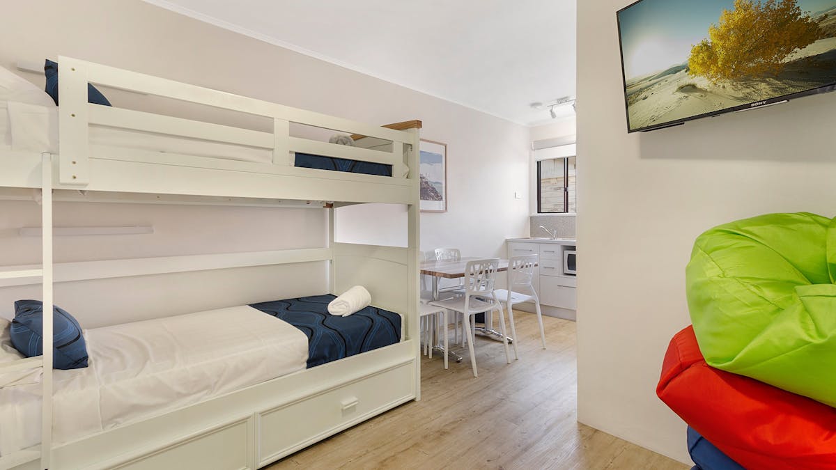 Bunks, television area and kitchenette area