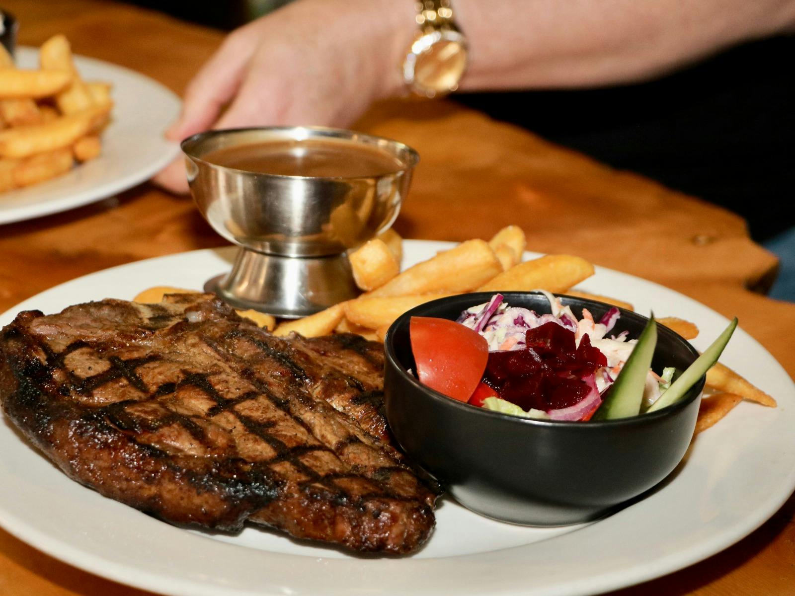 Scotch fillet steak with chips and salad