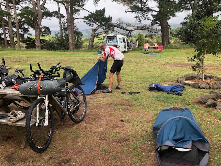 Rider setting up hike tent at camping reserve