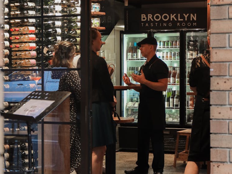 Discussing a wine with a brooklyn Tasting Room sommelier.