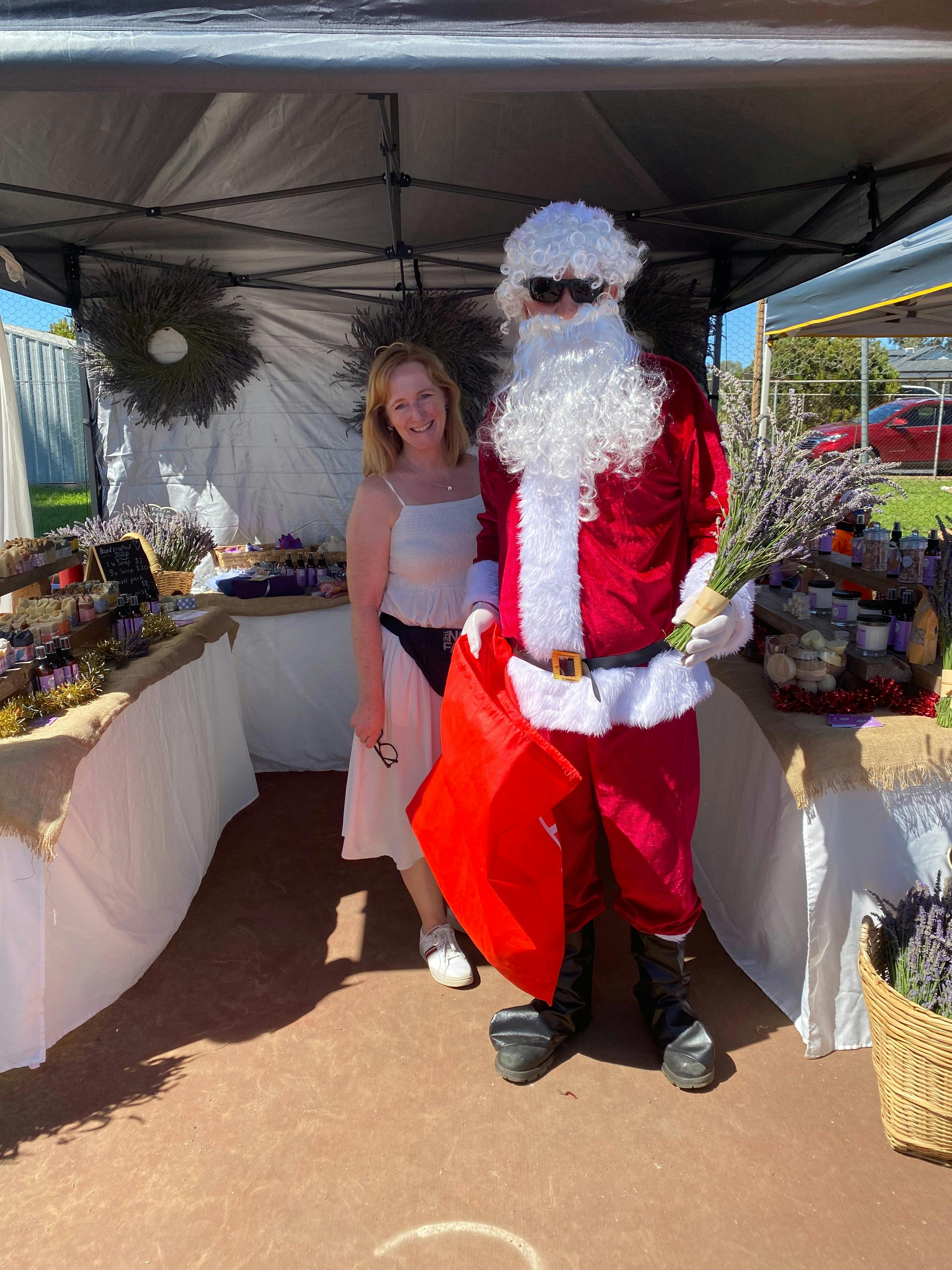 Last market of the year featuring Santa. He is posing with a stallholder holding lavender.