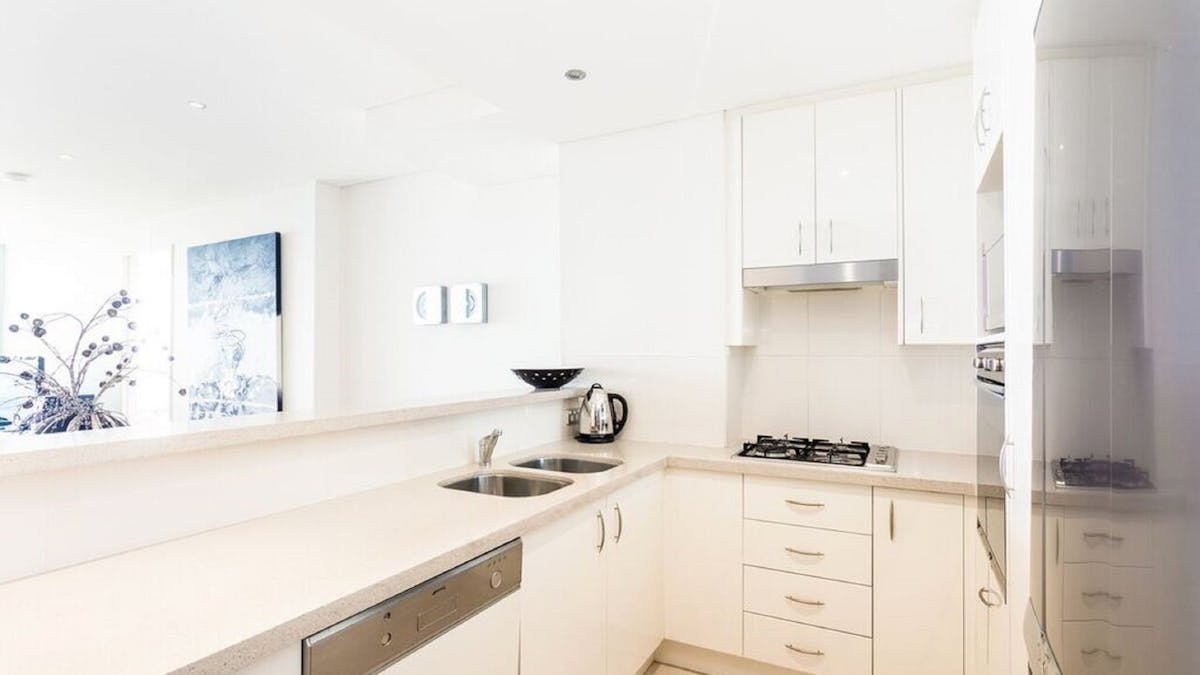 Spacious Kitchen area with Fridge, Dishwasher, Stove, Oven, Microwave and Utensils