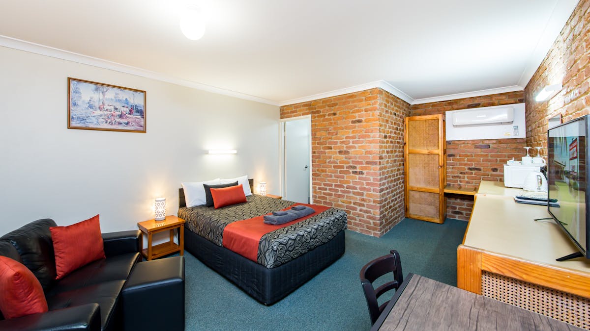 Spacious Queen room with lounge chair, table & chairs, smart TV, reverse cycle air-cond, microwave.