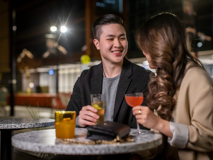 Couple enjoying cocktails at Re bar, Sydney