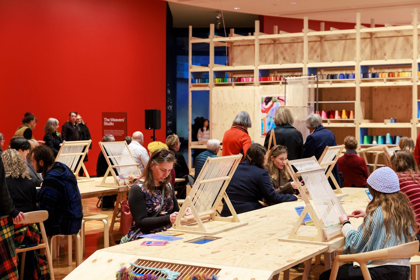 People sitting at a table weaving
