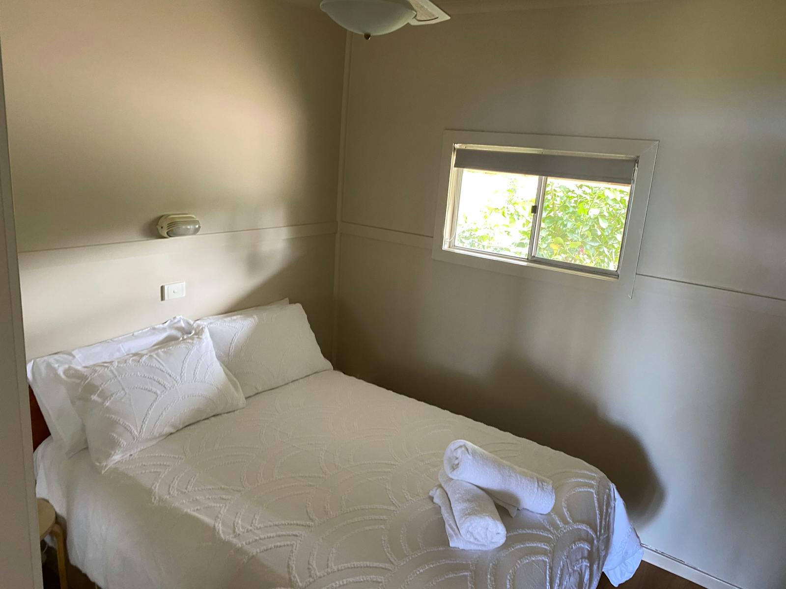 The main bedroom includes double bed, ceiling fan and wardrobe.