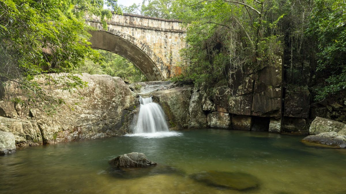 Stone bridge over a little waterfall.