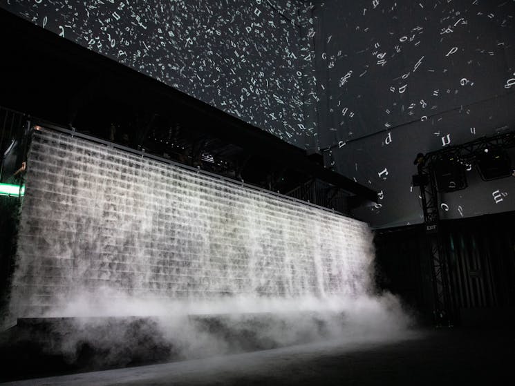 Image of the Cloud room featuring projections in the ceiling and an installation made of metal