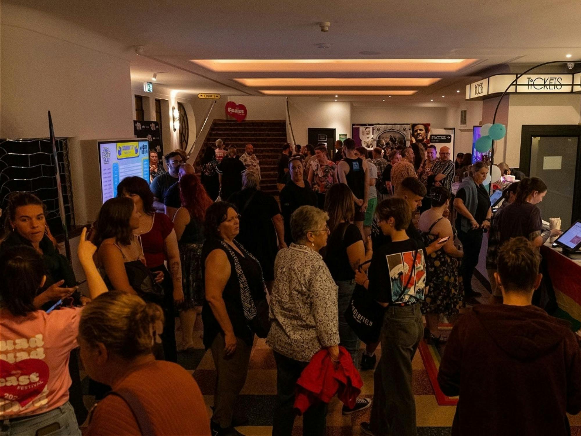 A crowd of people in the foyer of a venue