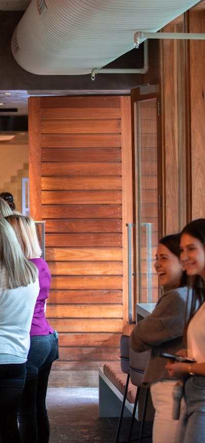 lINE OF PEOPLE WAITING TO COLLECT AND ORDER COFFEE