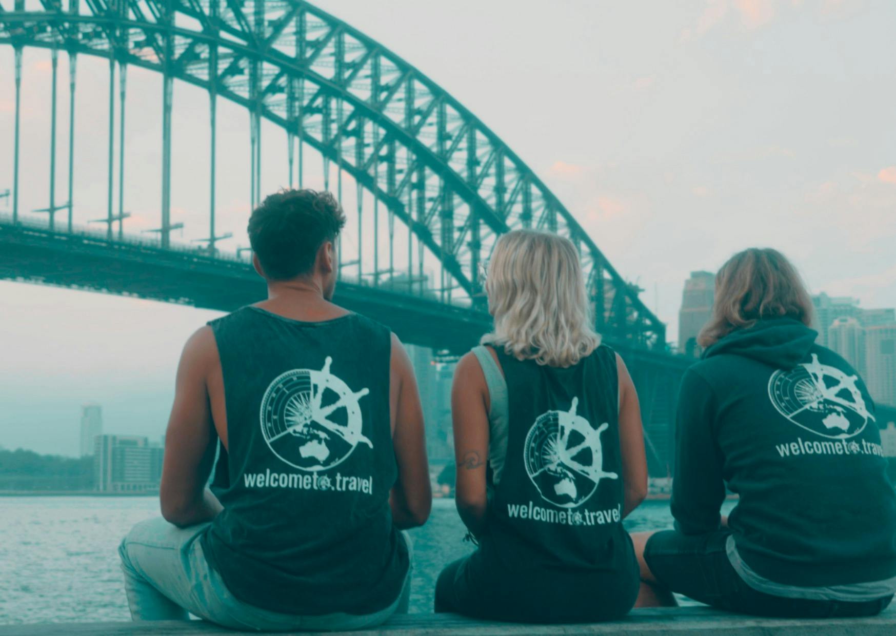 Three people looking out to the Sydney Harbour Bridge