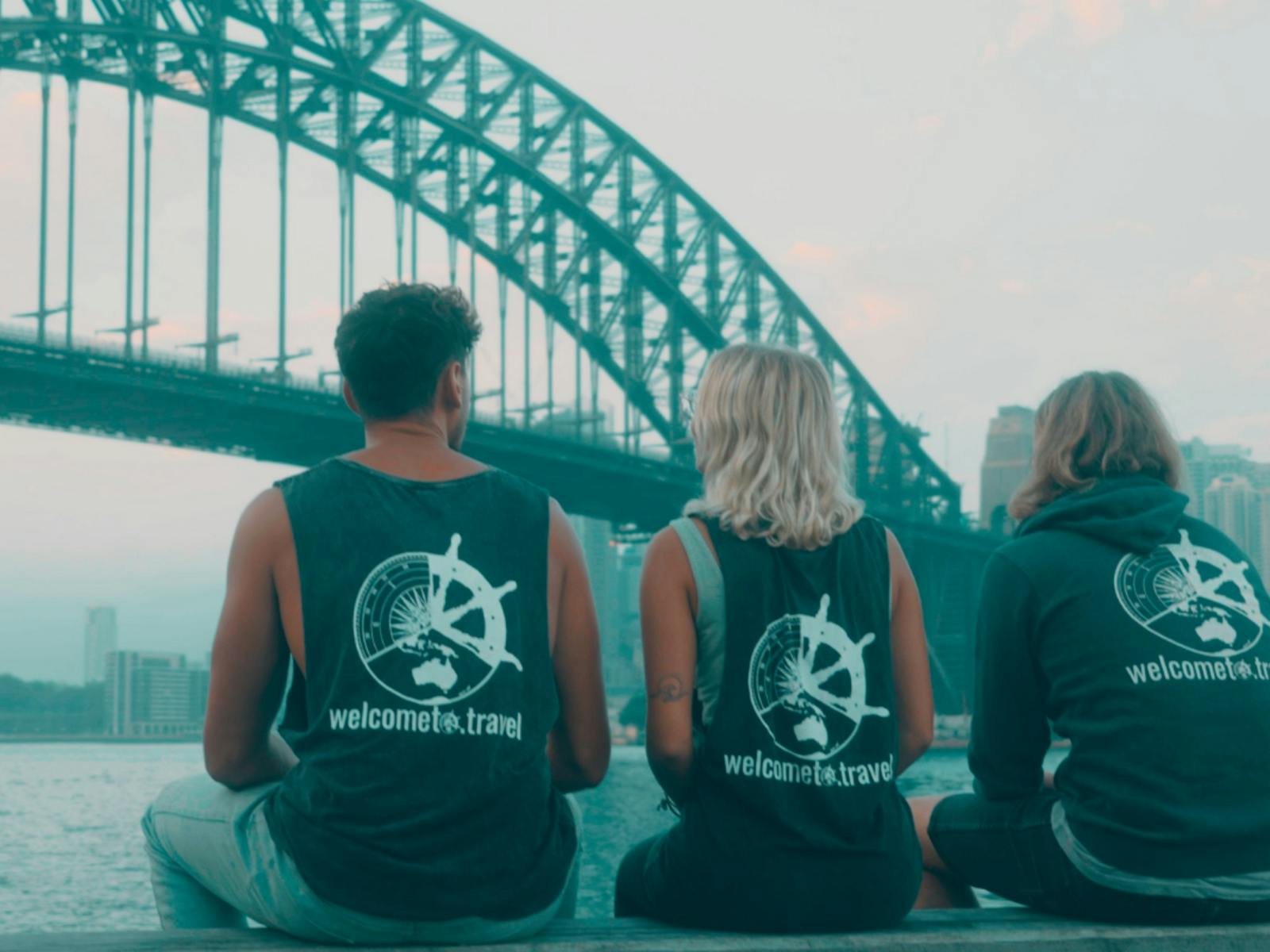 Three people looking out to the Sydney Harbour Bridge
