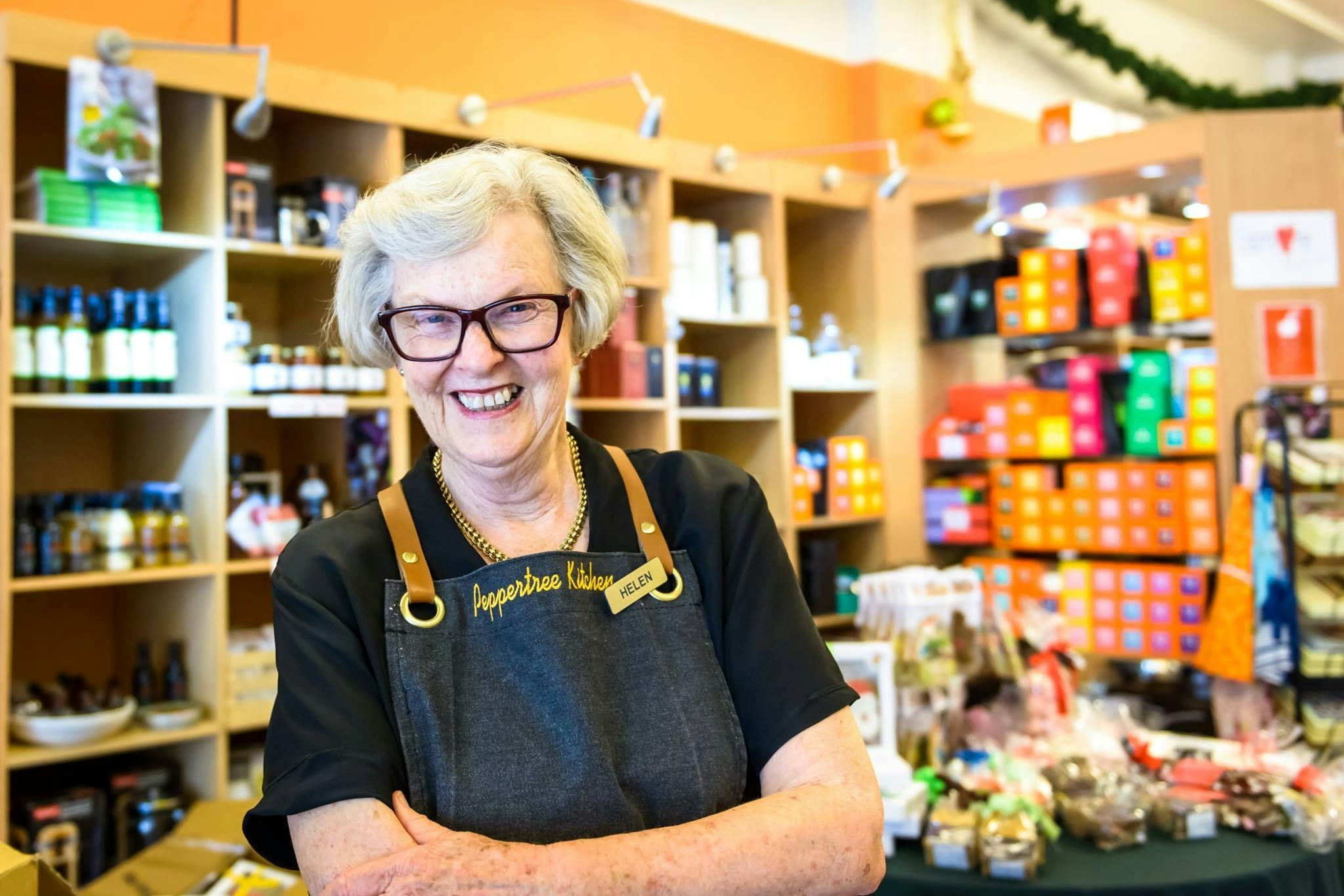 Helen the owner stands in front of shop display