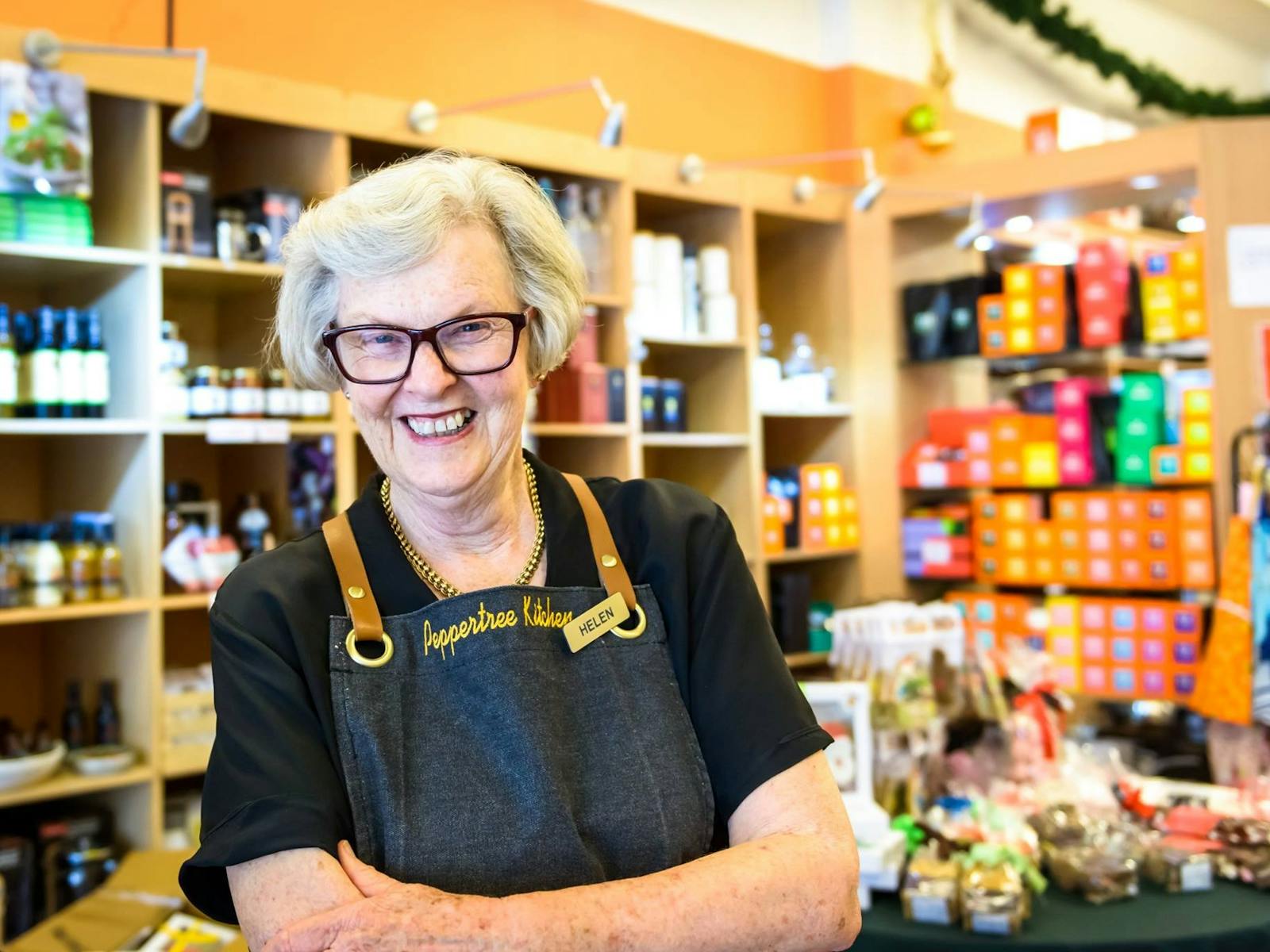 Helen the owner stands in front of shop display