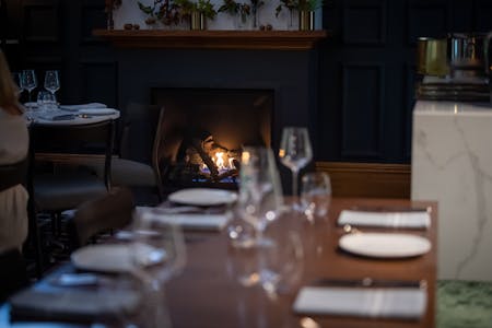 The cosy setting of Pastorale with our fireplace and tables