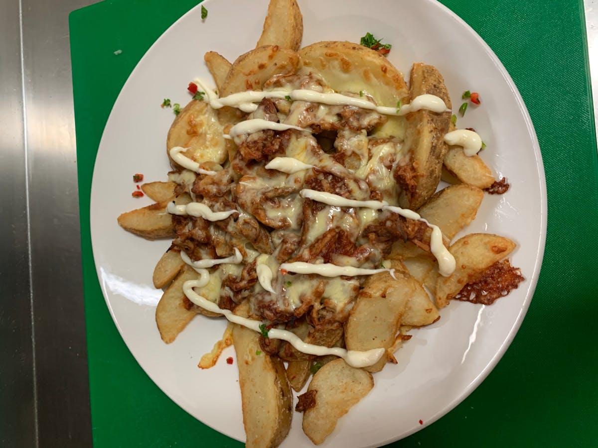 Crisp Wedges with pulled pork, pirate sauce, melted cheese and sour cream