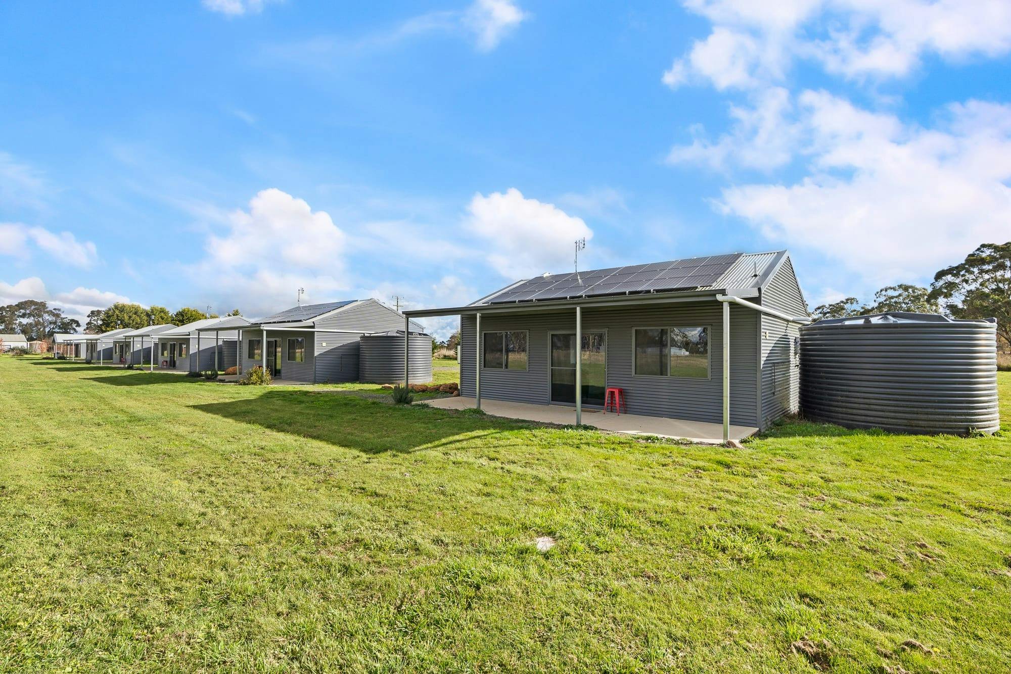 5 grey tin cabins in regional NSW, managed by Book Regional