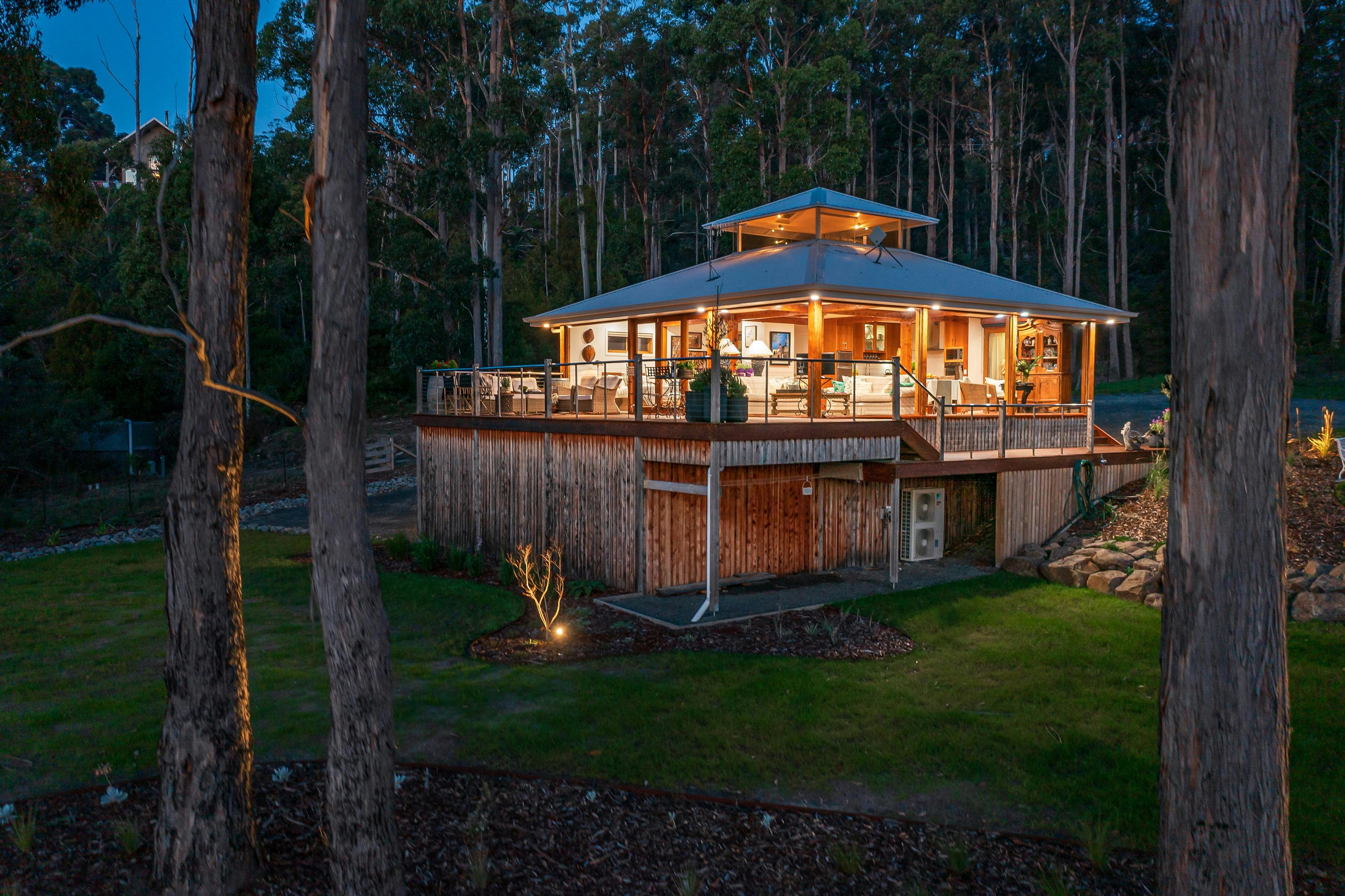 A wide shot of the Huon River Hideaway facing away from the river at dusk