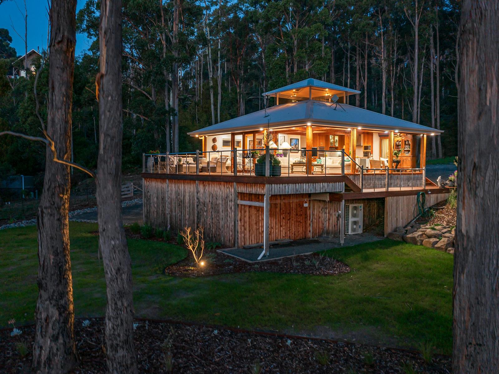 A wide shot of the Huon River Hideaway facing away from the river at dusk