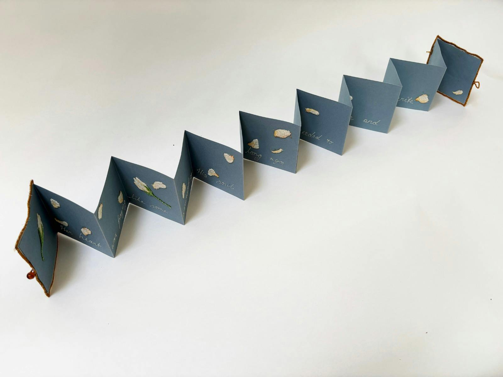 Folded paper material with writing and floral illustrations