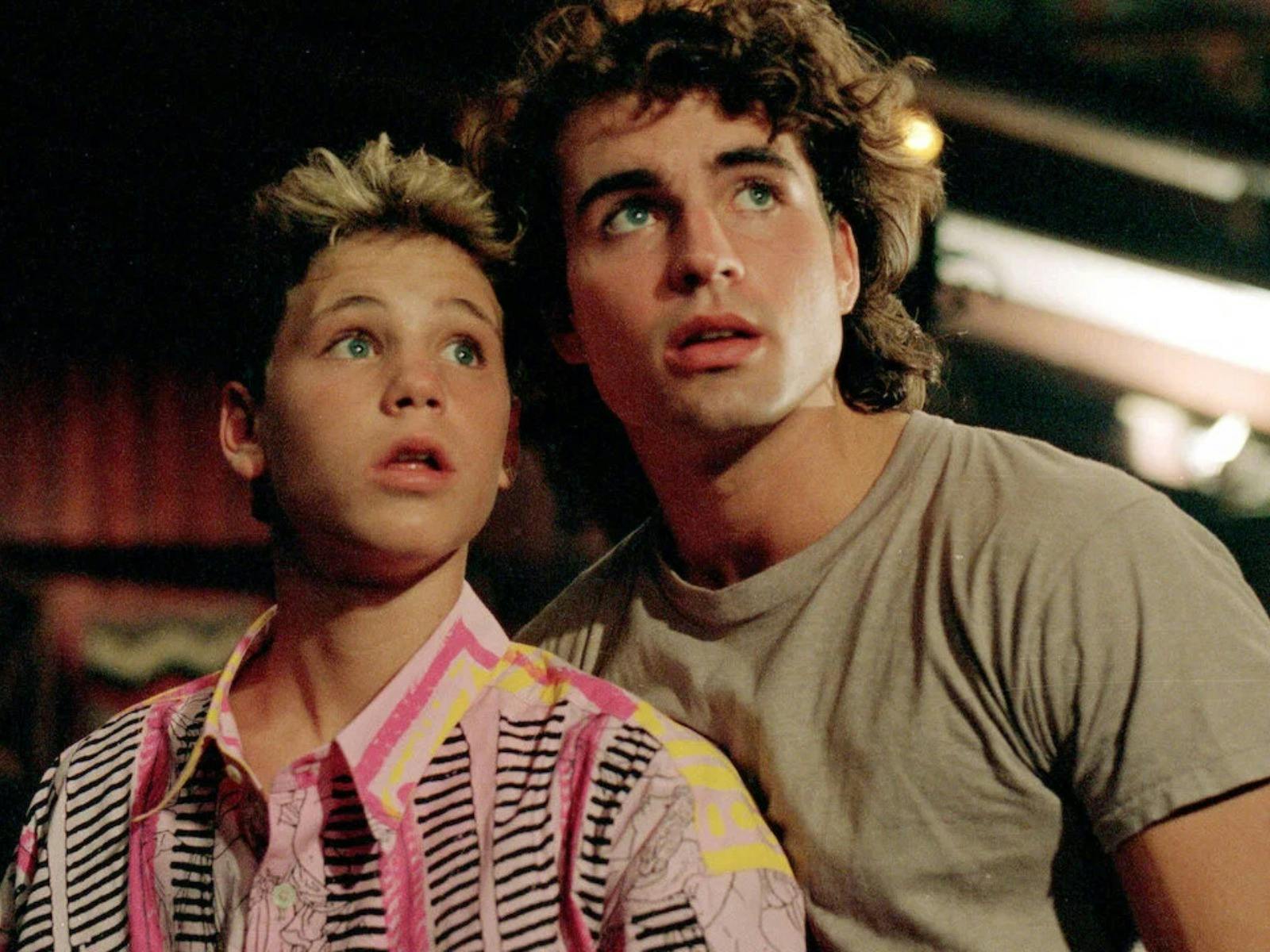 Two young boys looking up frightened