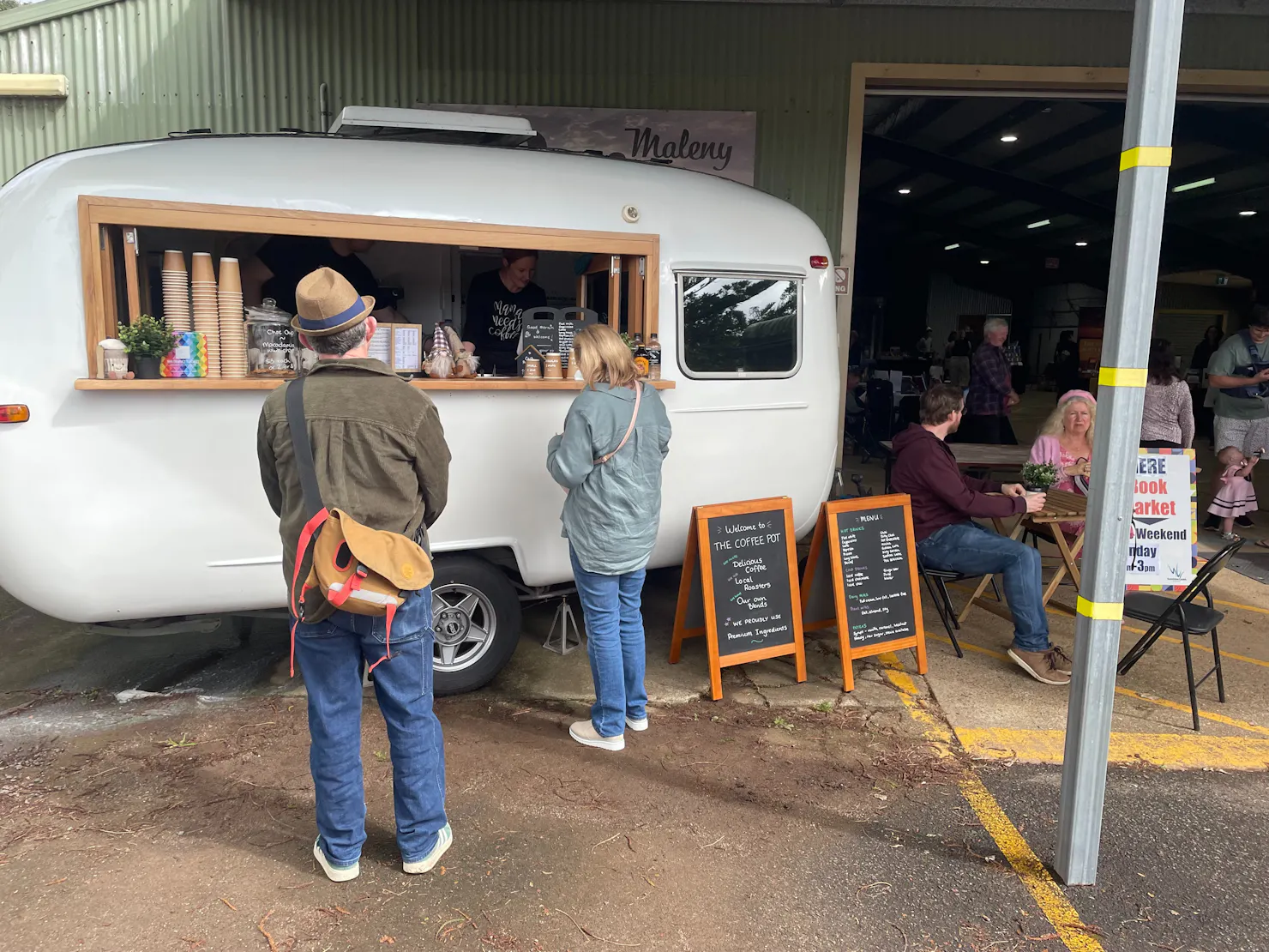 People ordering coffee from a small white van