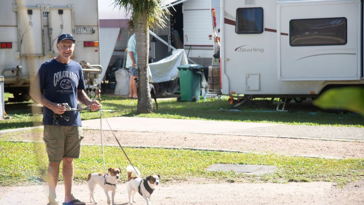 A man taking his dogs for a walk