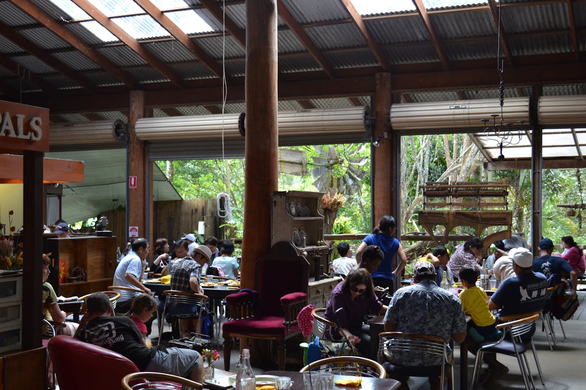 Looking through the restaurant with an old piano frame hanging in the background.