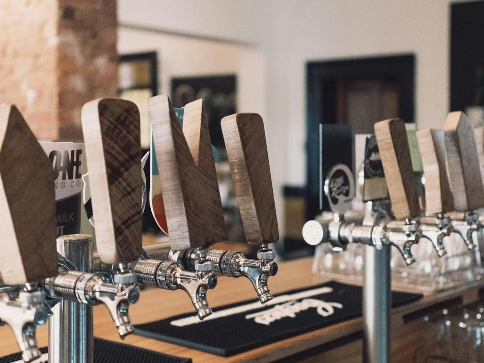 A picture of our beer taps with repurposed wood  from our 2020 renovation.