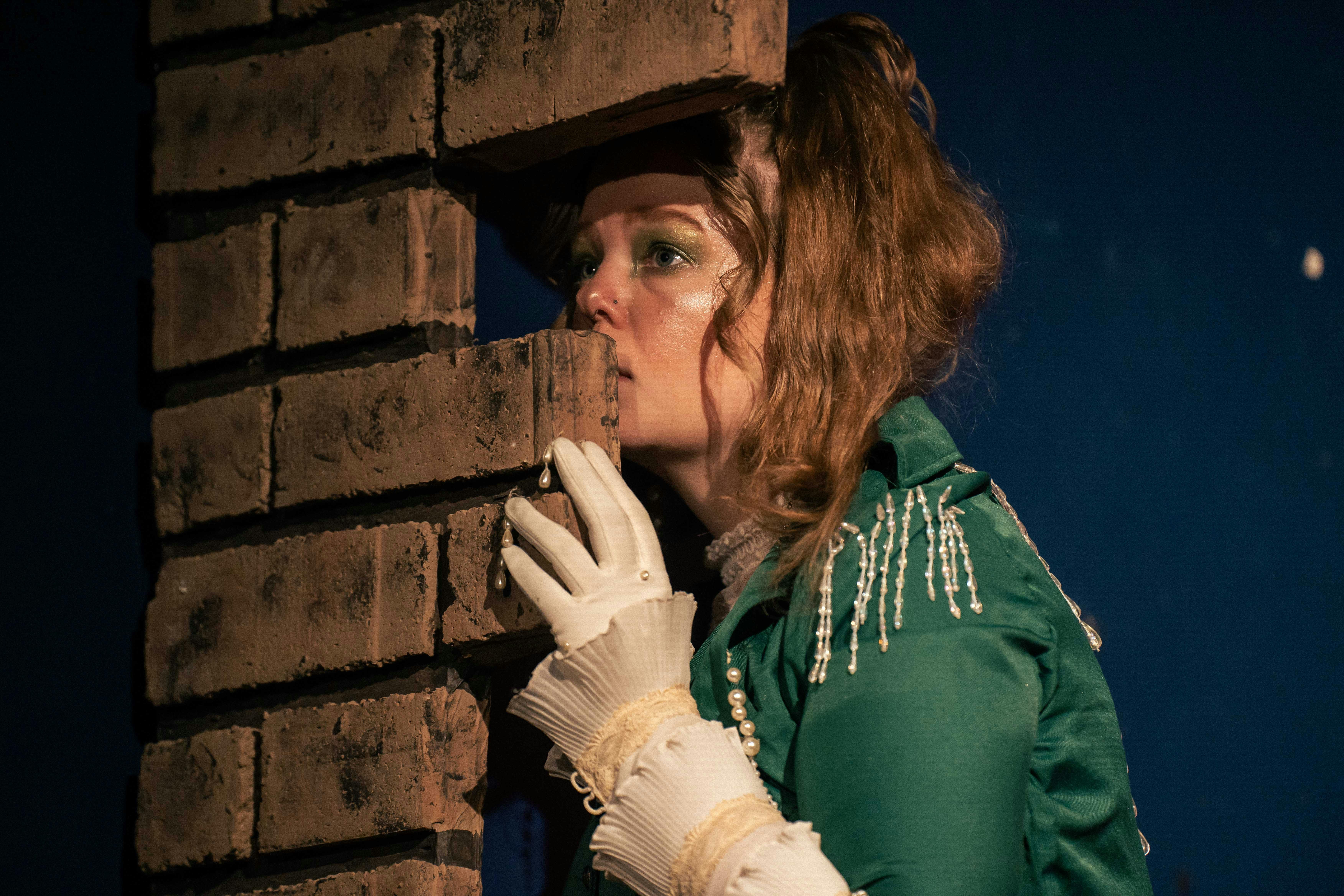 a person hiding behind a wall