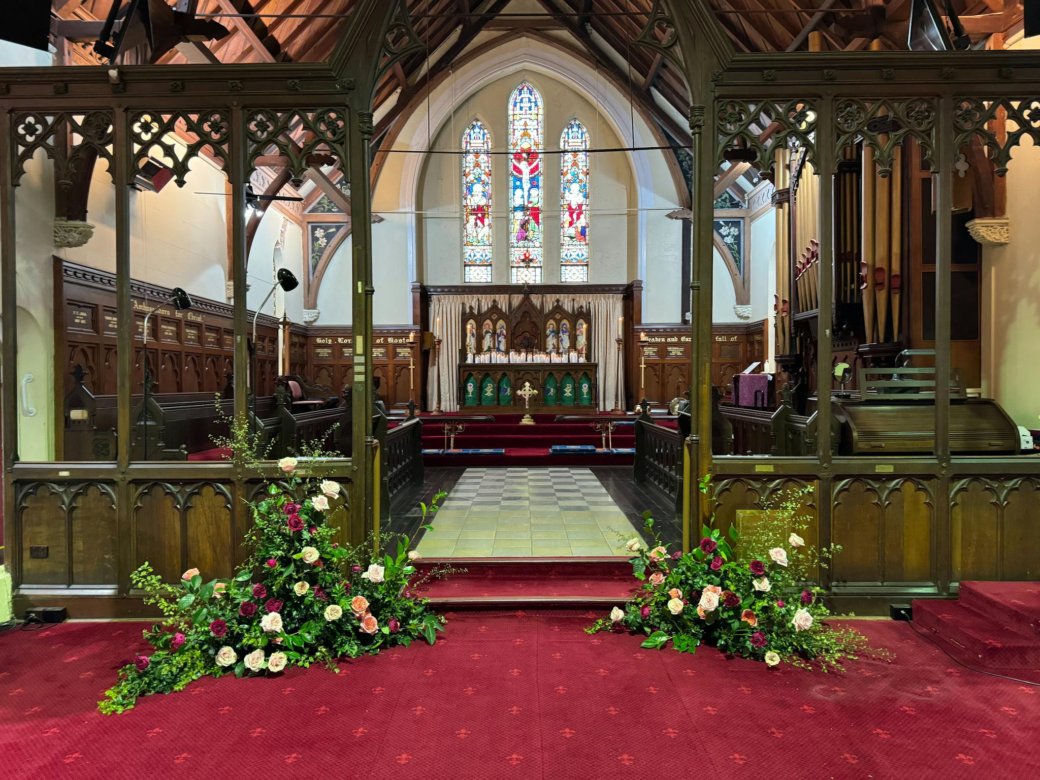 The interior of the church showing the chancel and altar along with stained-glass windows. The interior of the church showing the chancel and altar along with stained-glass windows.