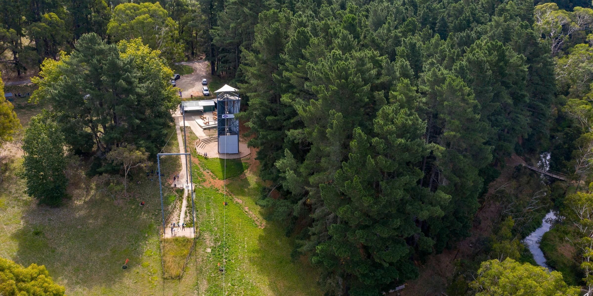 Aerial view of the adventure hub surrounded by pine trees