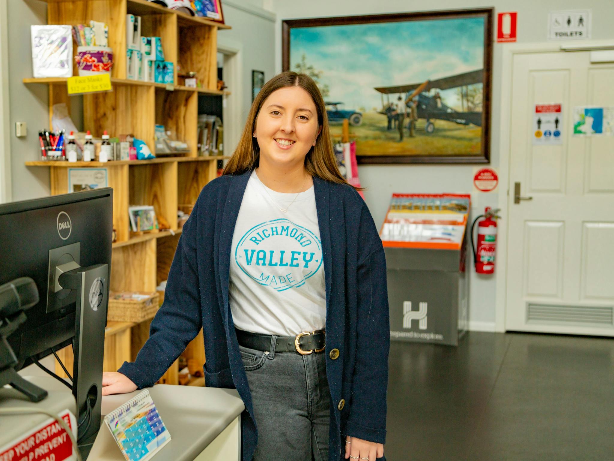 Lady inside visitor centre standing in front of desk