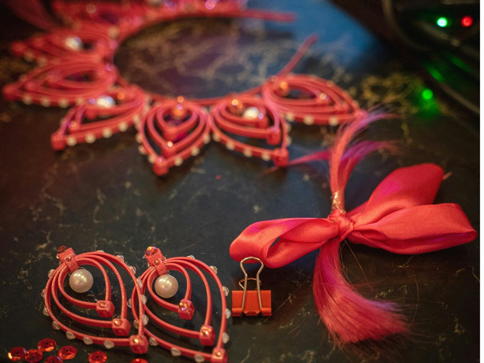 pink jewellery and a lock of pink hair on a table