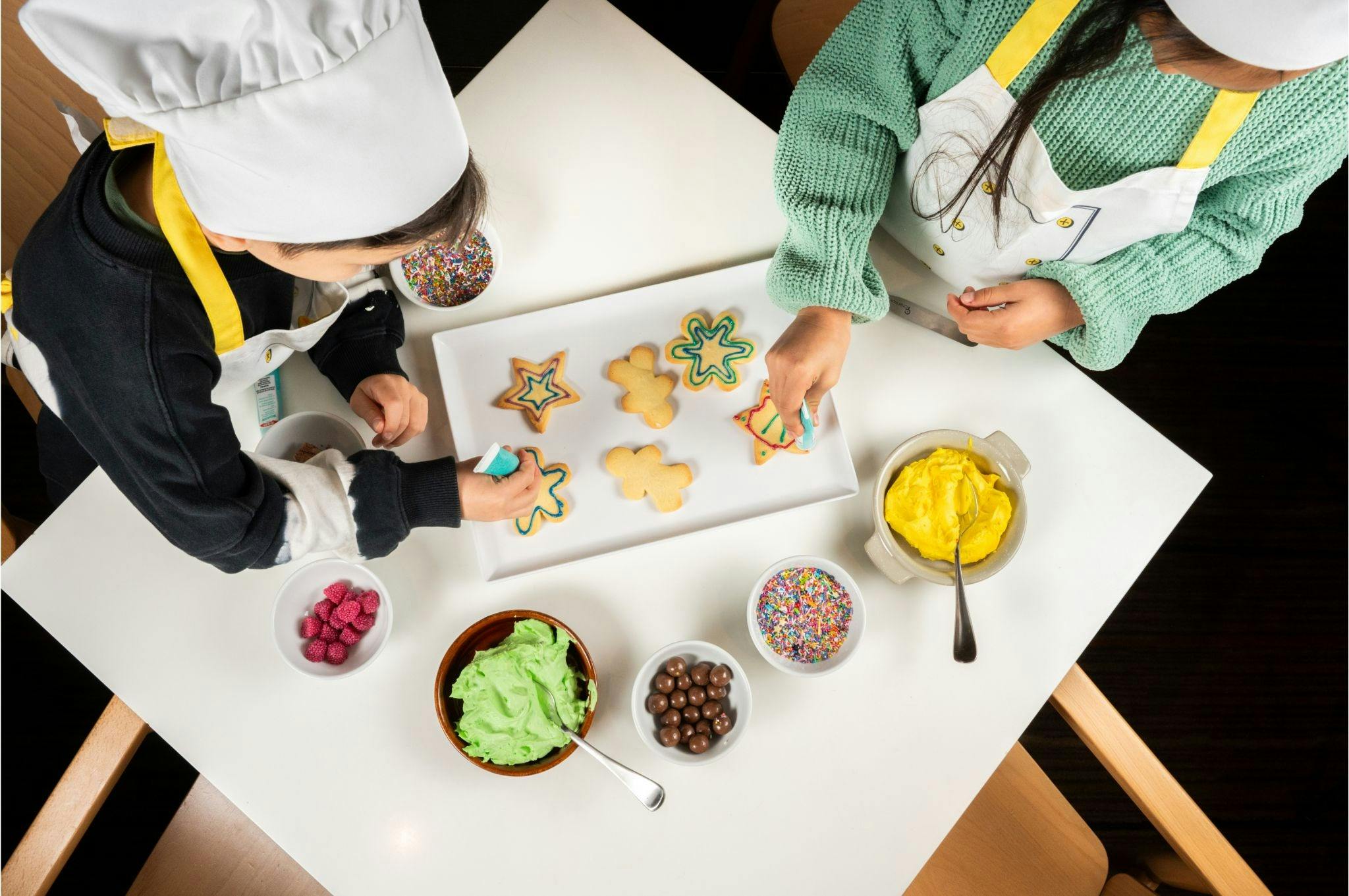 Kids decorating festive cookies