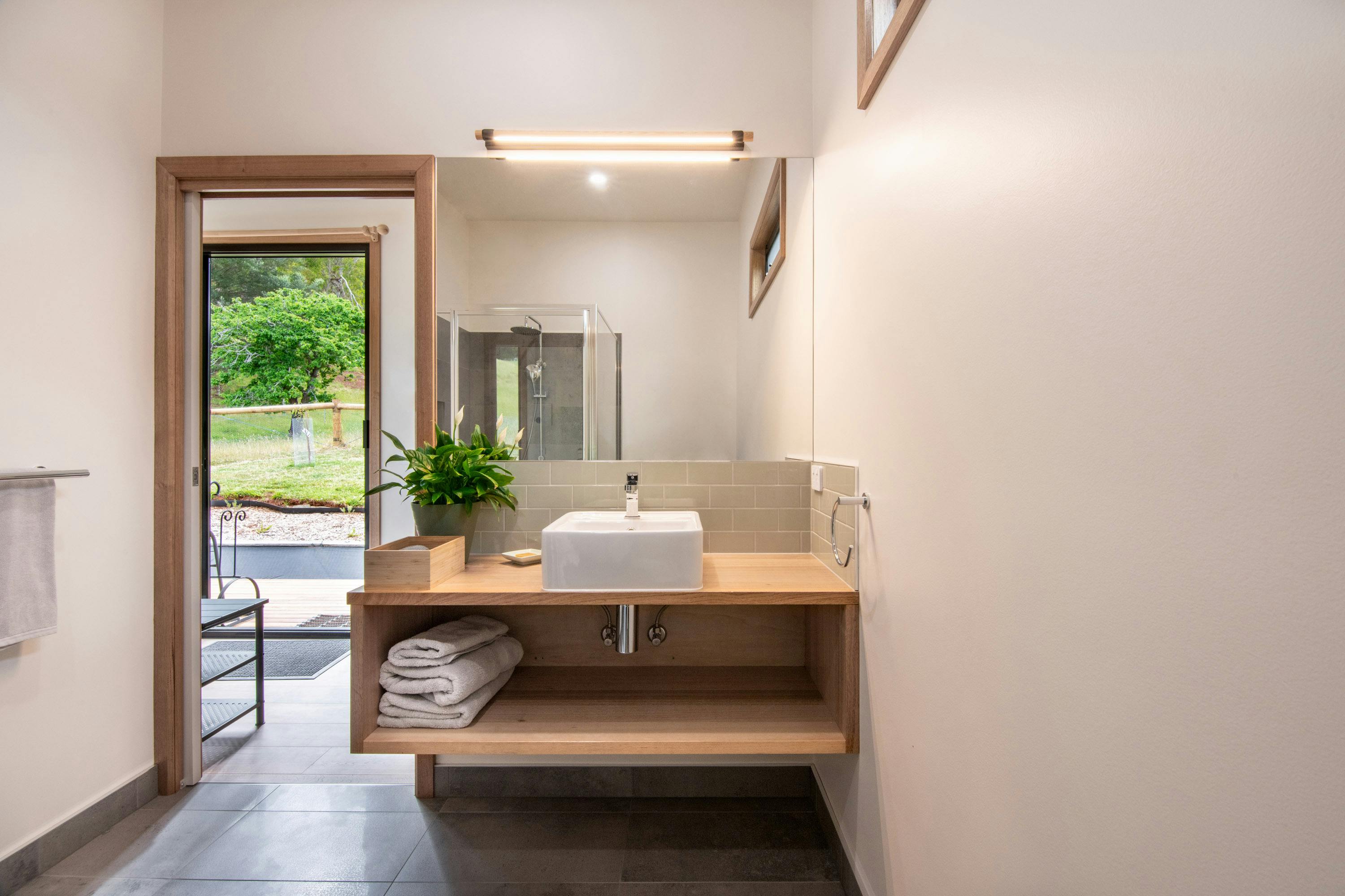 bathroom vanity with natural timber bench