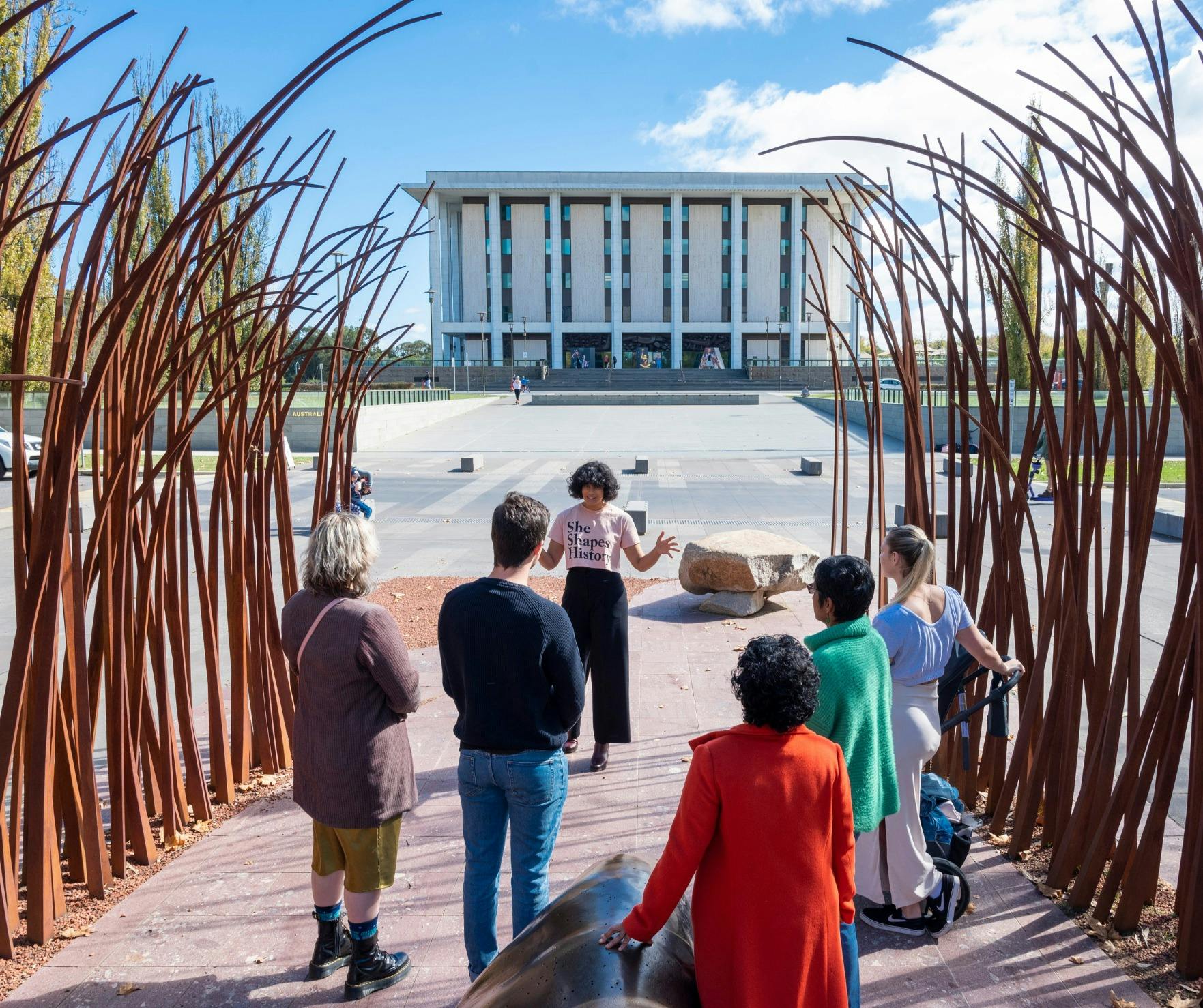 Tour guide Sita with tour group out the front of the National Library of Australia