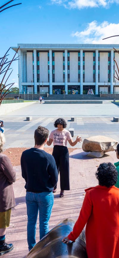 Tour guide Sita with tour group out the front of the National Library of Australia