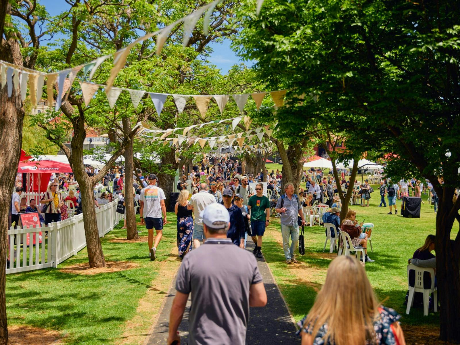 A group of people walking through the pathway at CheeseFest