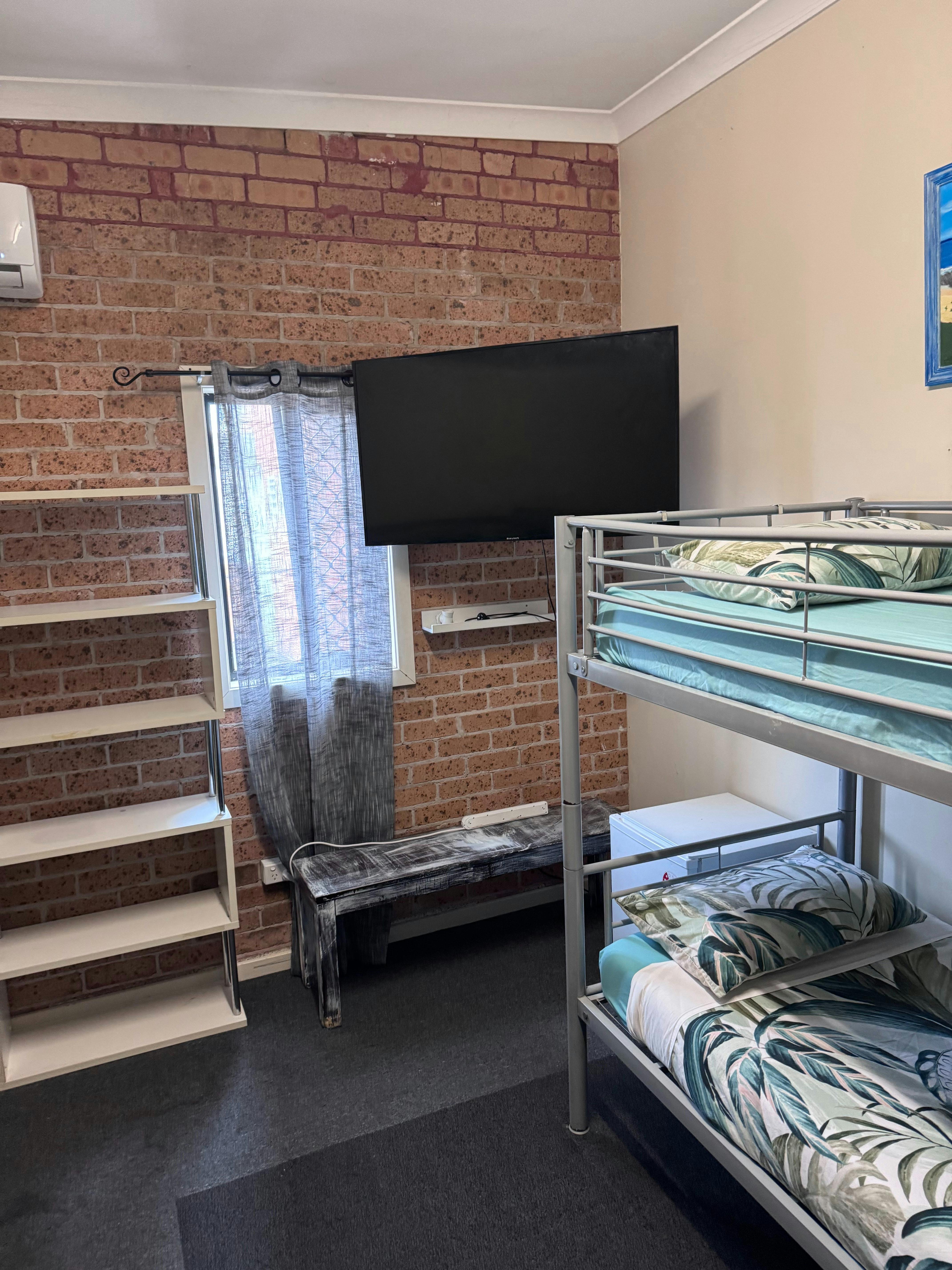 Bunk beds in the family room, mini fridge and a tv.