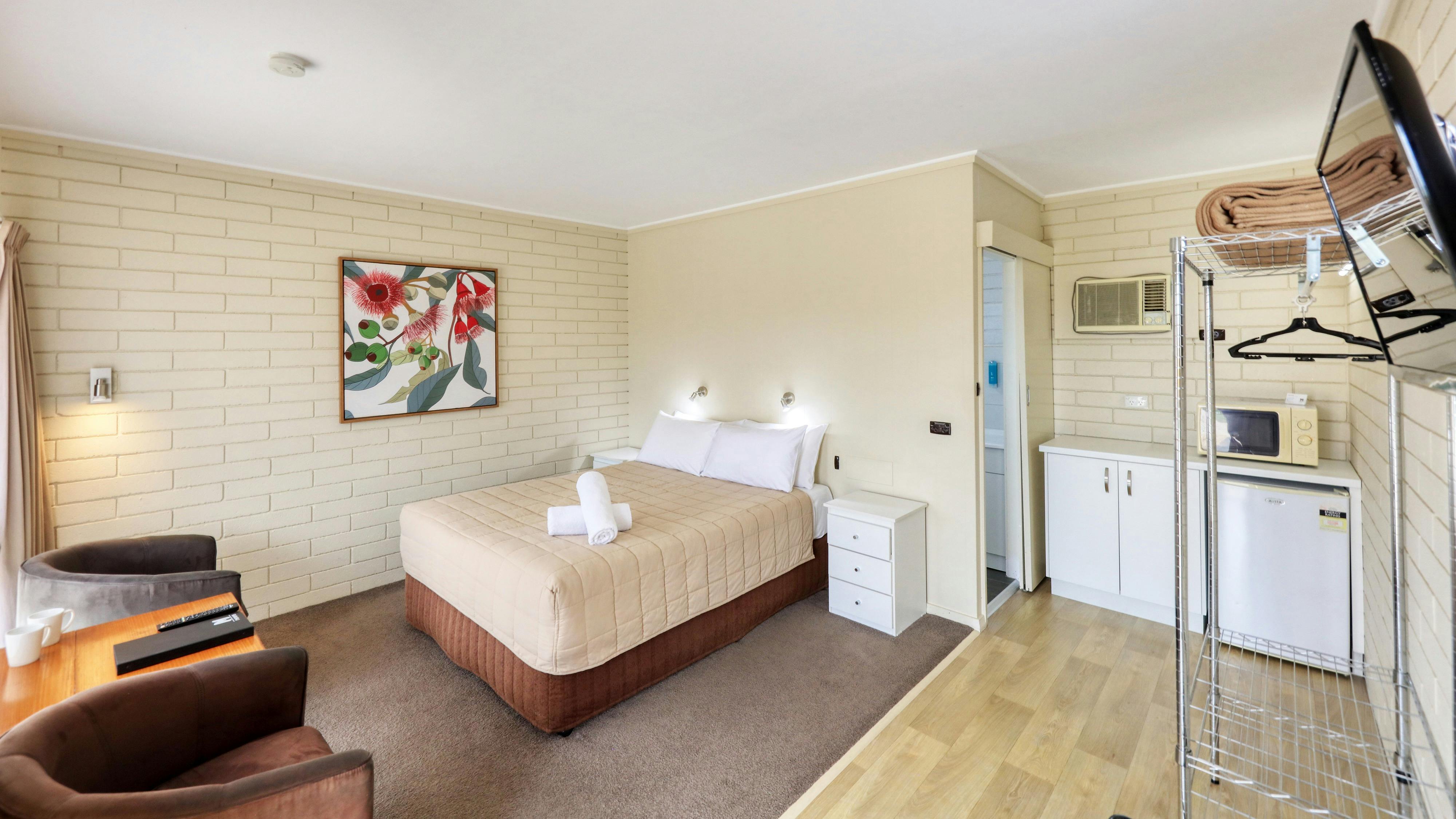 Queen Room showing bed area and entrance to ensuite bathroom.