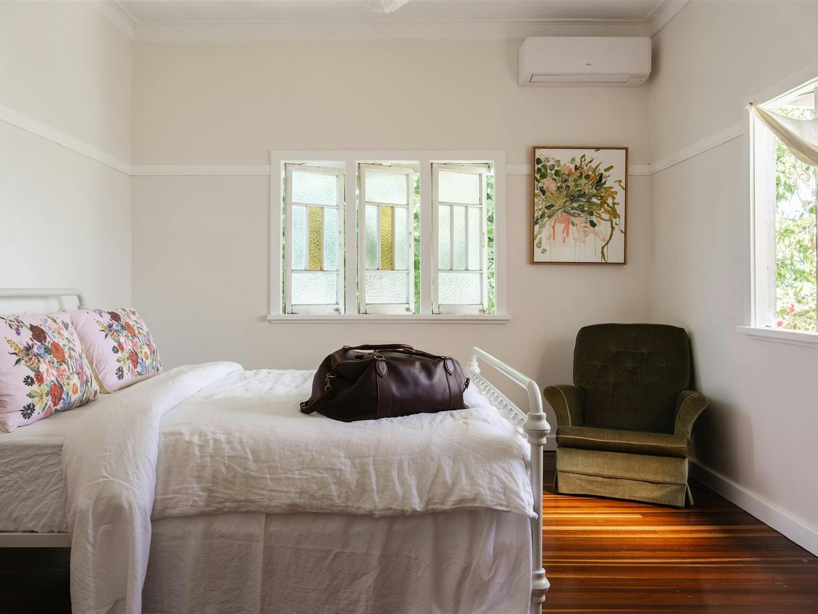 Bedroom with antique chair in the corner and white linen sheets. Bedroom with antique chair in the corner and white linen sheets.