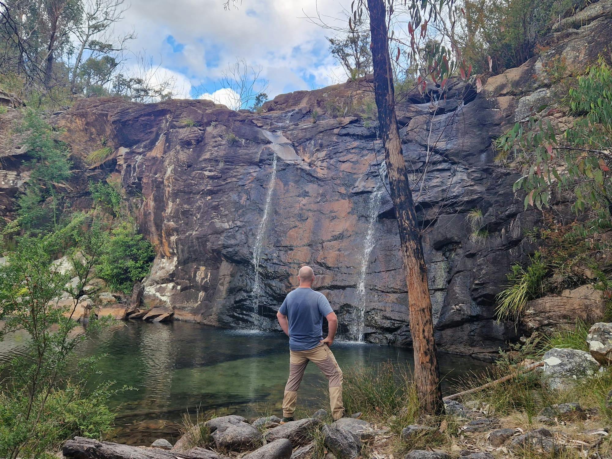 Guide standing in front of beautiful twin falls