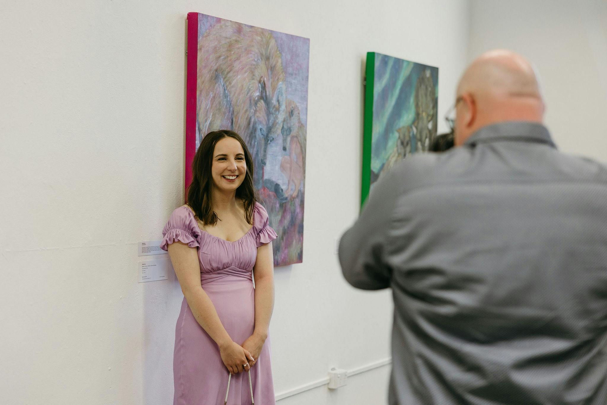 Student in front of their work at the graduating exhibition
