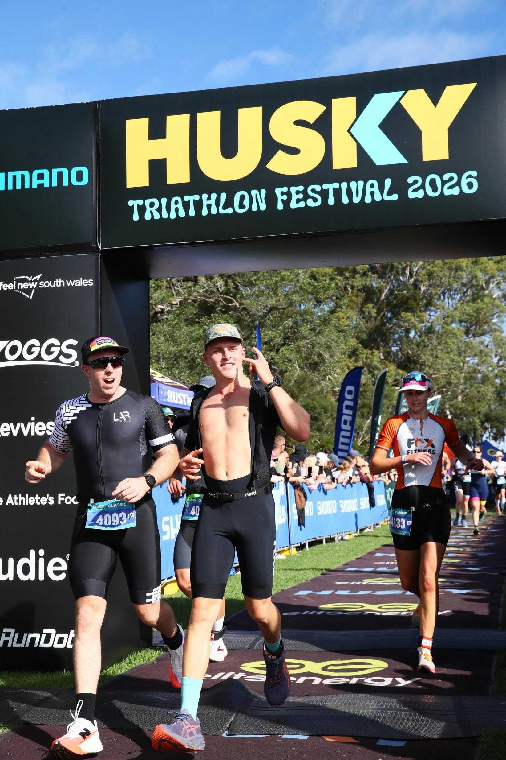 men crossing finish line