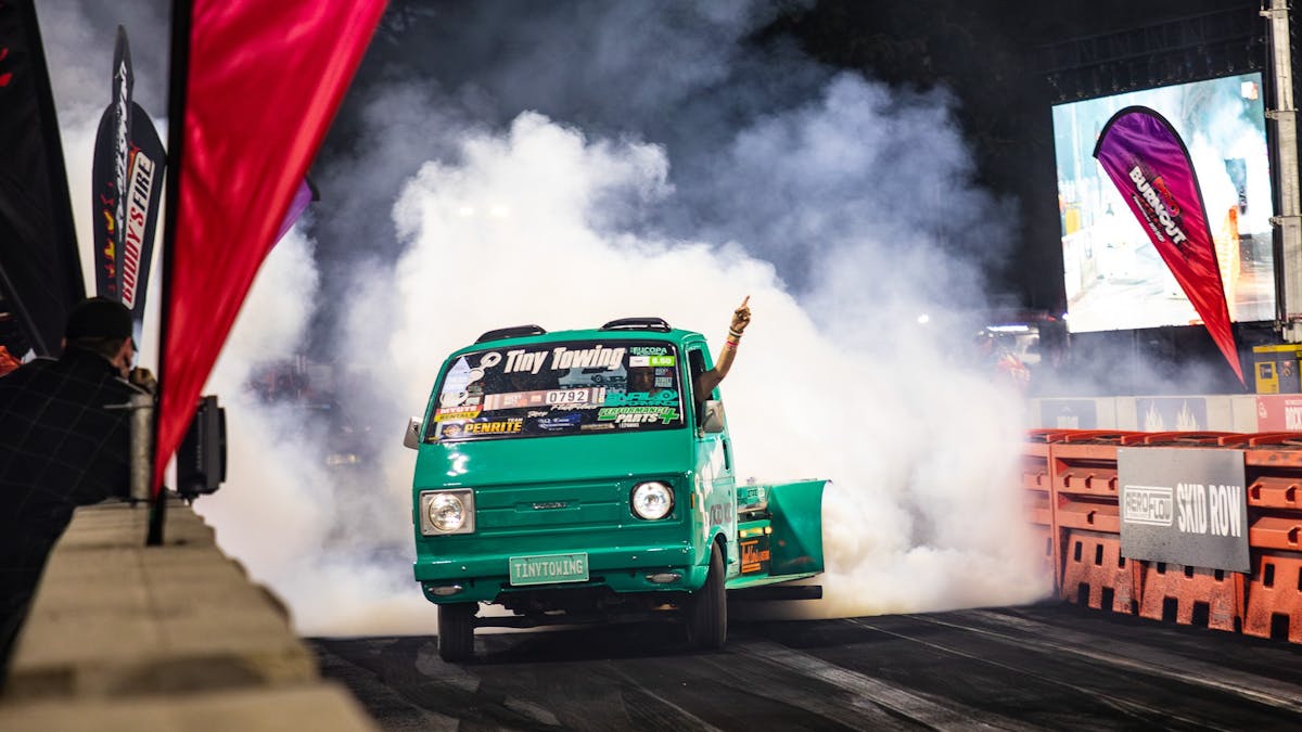 Vehicle performing a burnout on a track with tyre smoke at Rockynats.